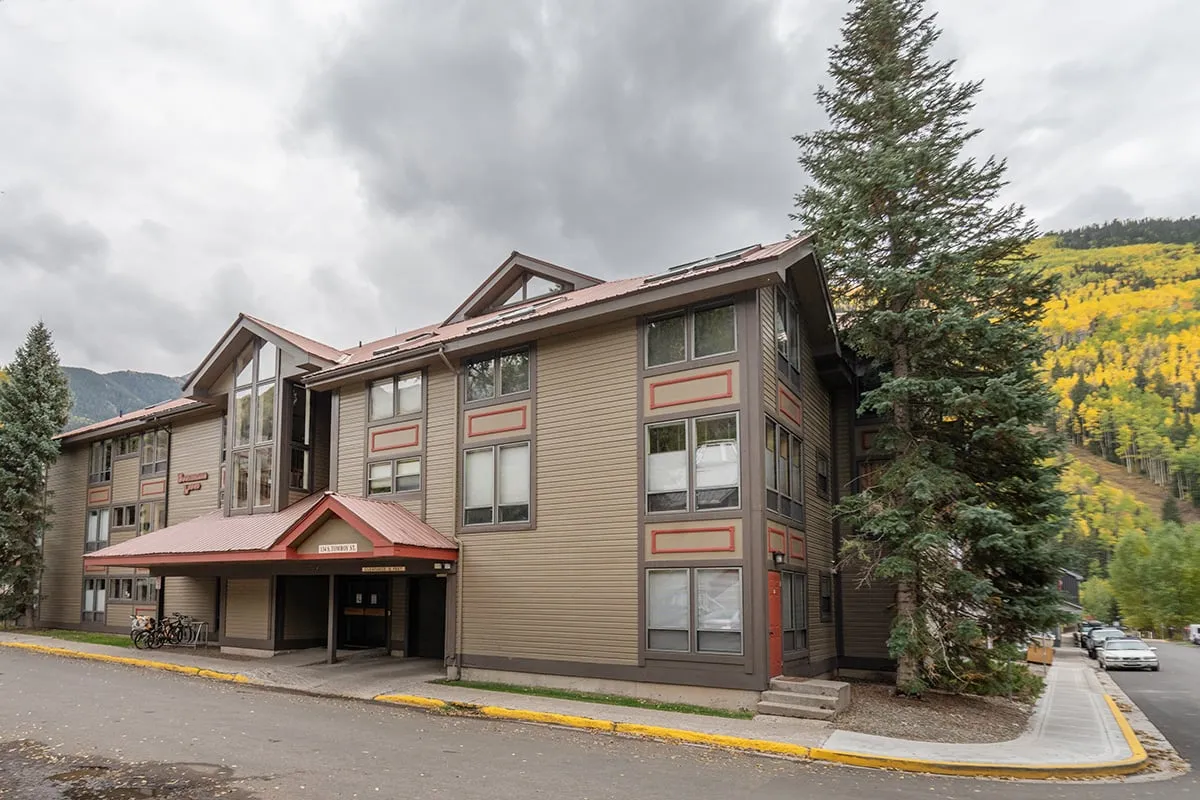 This image showcases the welcoming facade of Boomerang Lodge, surrounded by lush trees and set against a peaceful landscape. The building's entrance canopy and serene environment invite families to explore and enjoy the area right outside their door.